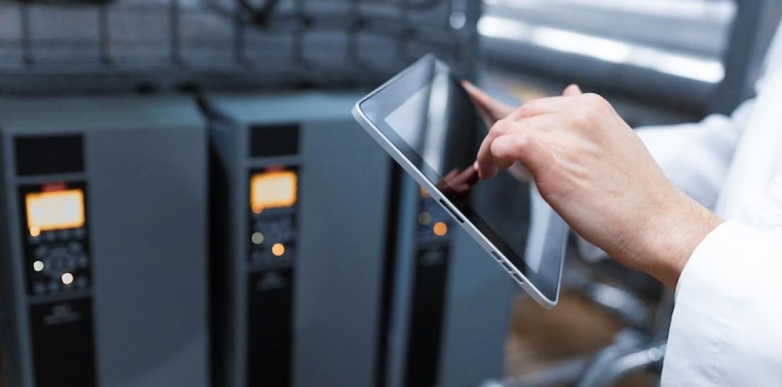technologist-with-grey-tablet-his-hands-make-set-up-production-line-while-standing-department-dairy-factory_645730-724